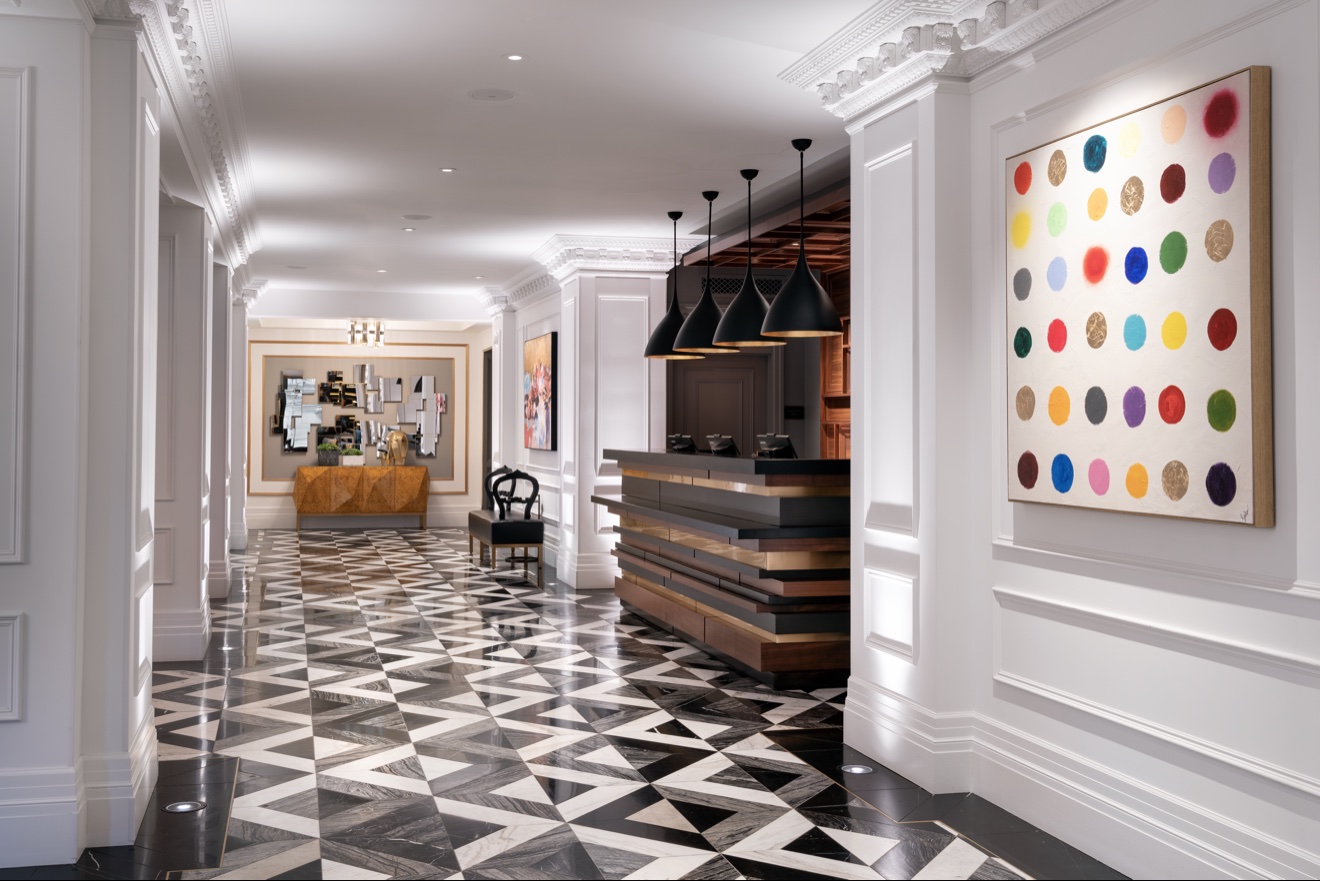 Hotel corridor with graphic black-and-white flooring and colorful artwork