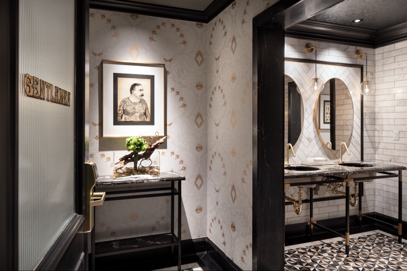 Fitness center entry with patterned wallcovering and portrait art