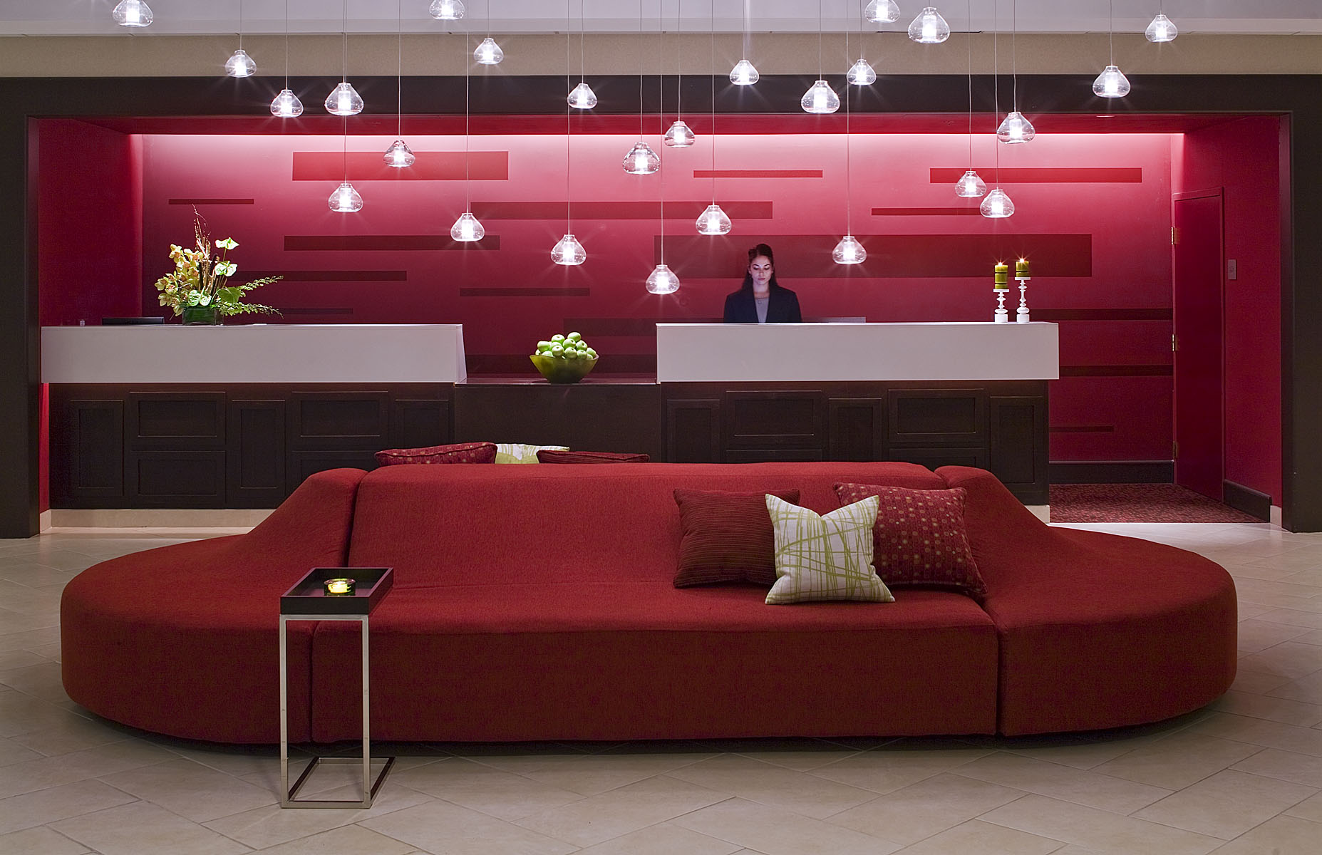 Crowne Plaza hotel bar with a sweeping red banquette and suspended lights