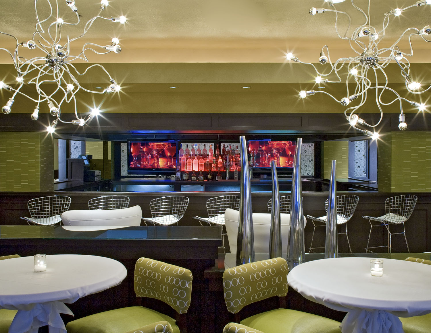 Open hotel lounge with varied seating groups and warm overhead lighting