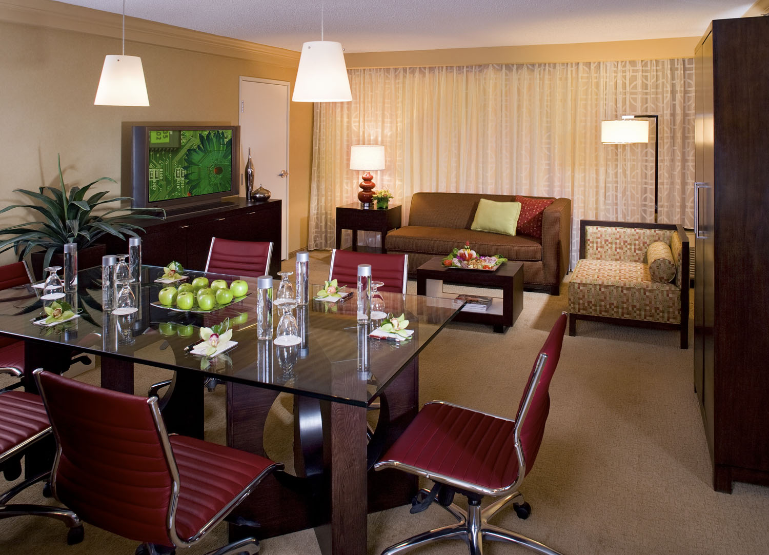 Meeting room arranged with U-shaped tables and conference seating