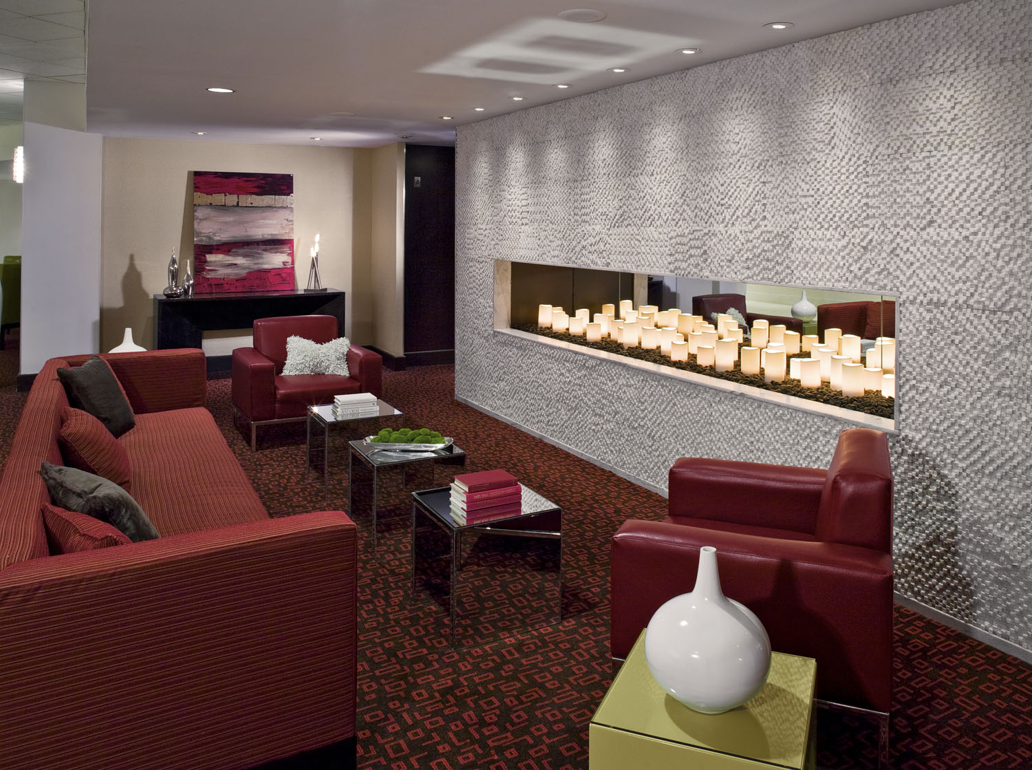 Guest suite lounge with a sofa, work surface, and hospitality cabinet