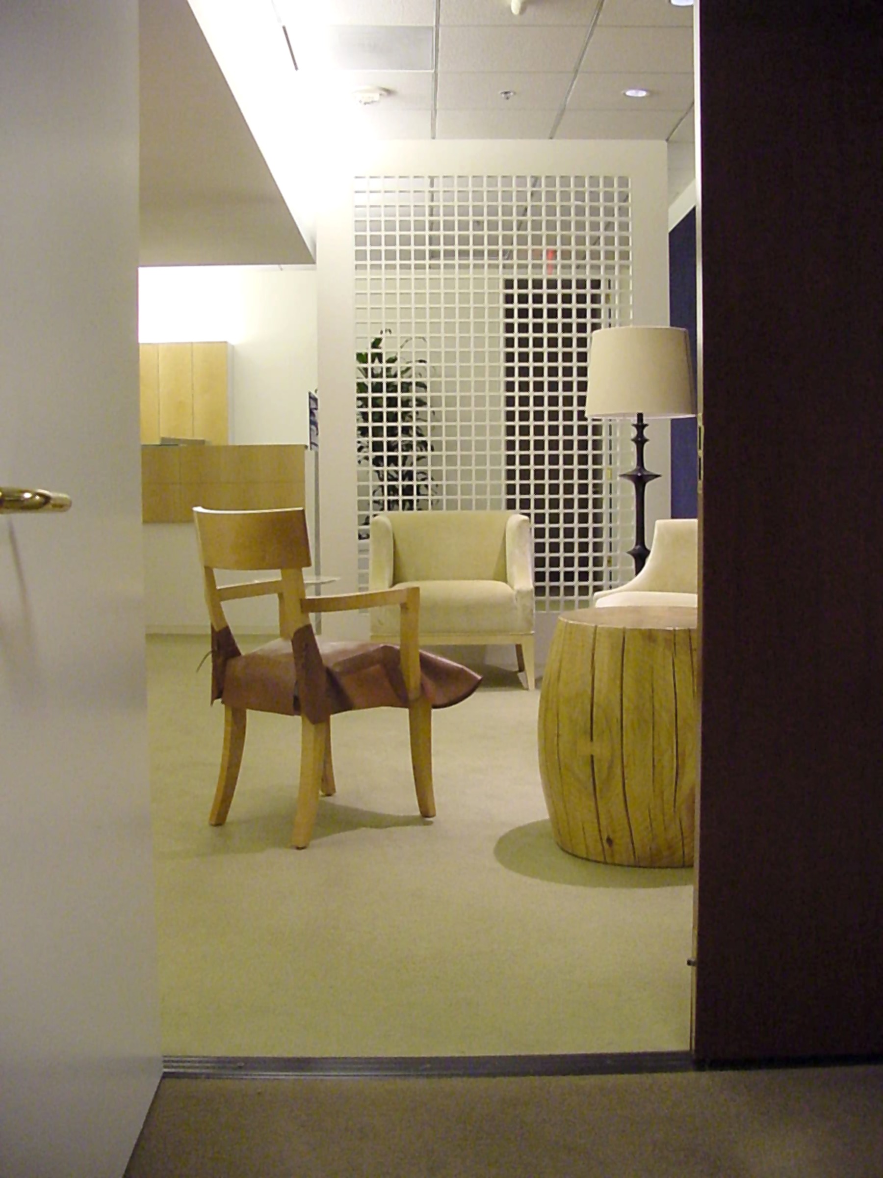 Entravision waiting area with light wood seating and a gridded screen