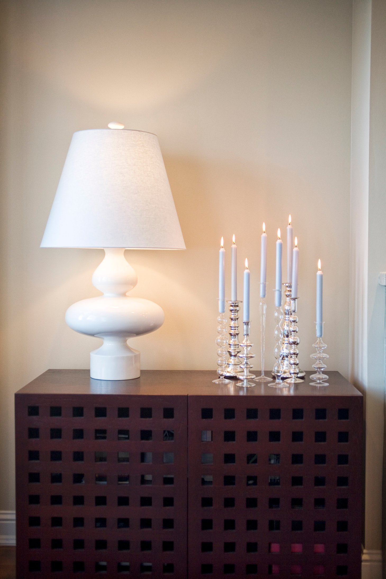 Green Street B Residence bedroom detail with a table lamp and dark chest