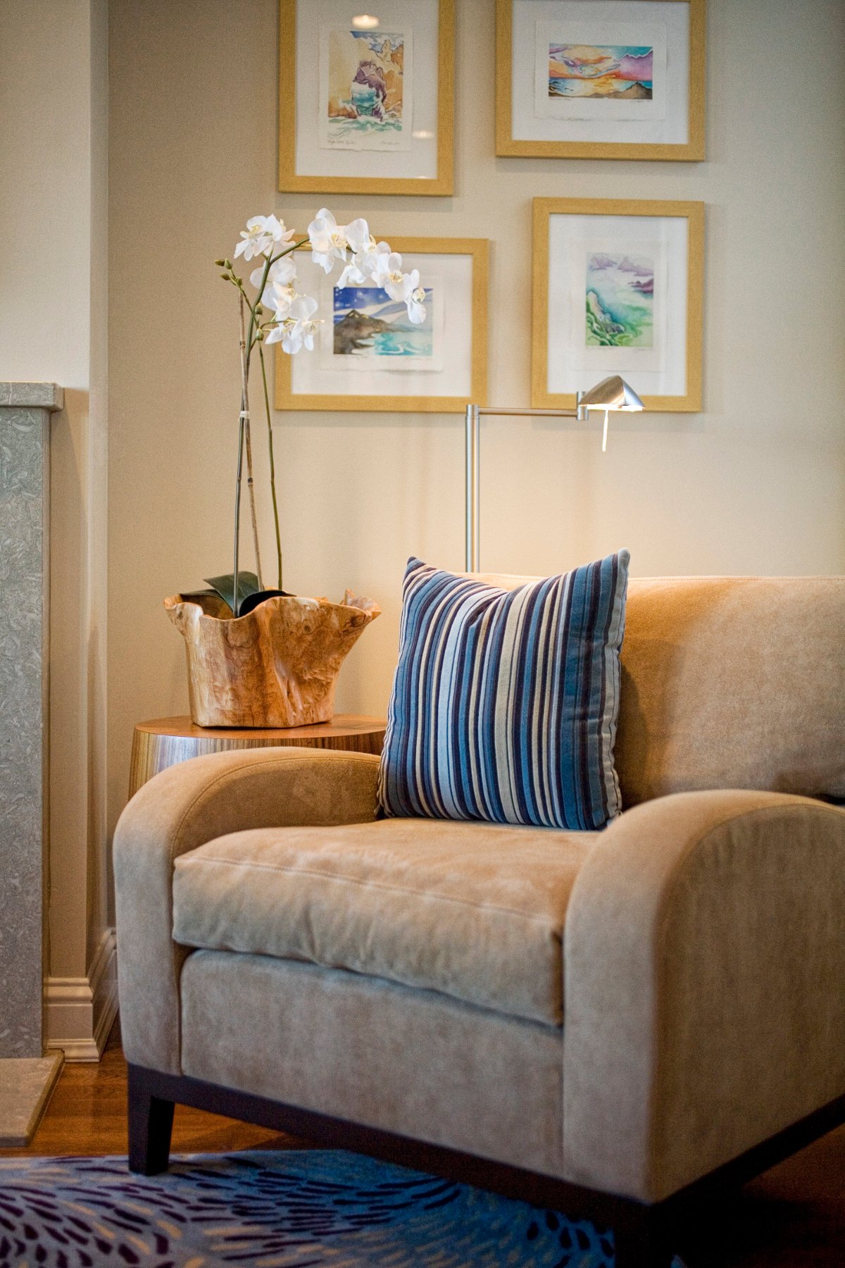 Green Street B Residence reading corner with a blue armchair and framed art