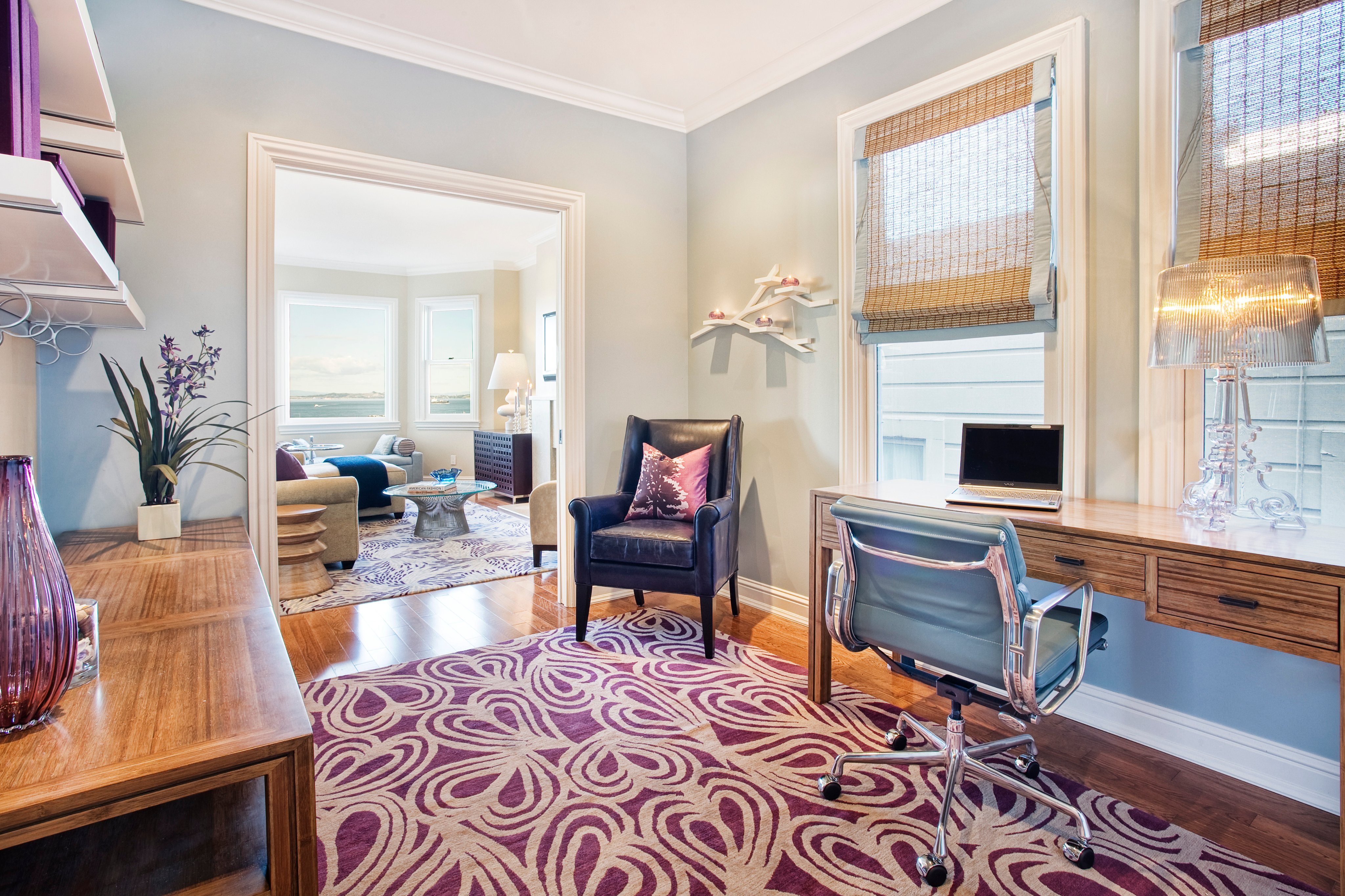 Green Street B Residence study with a leather armchair, wood desk, and patterned rug