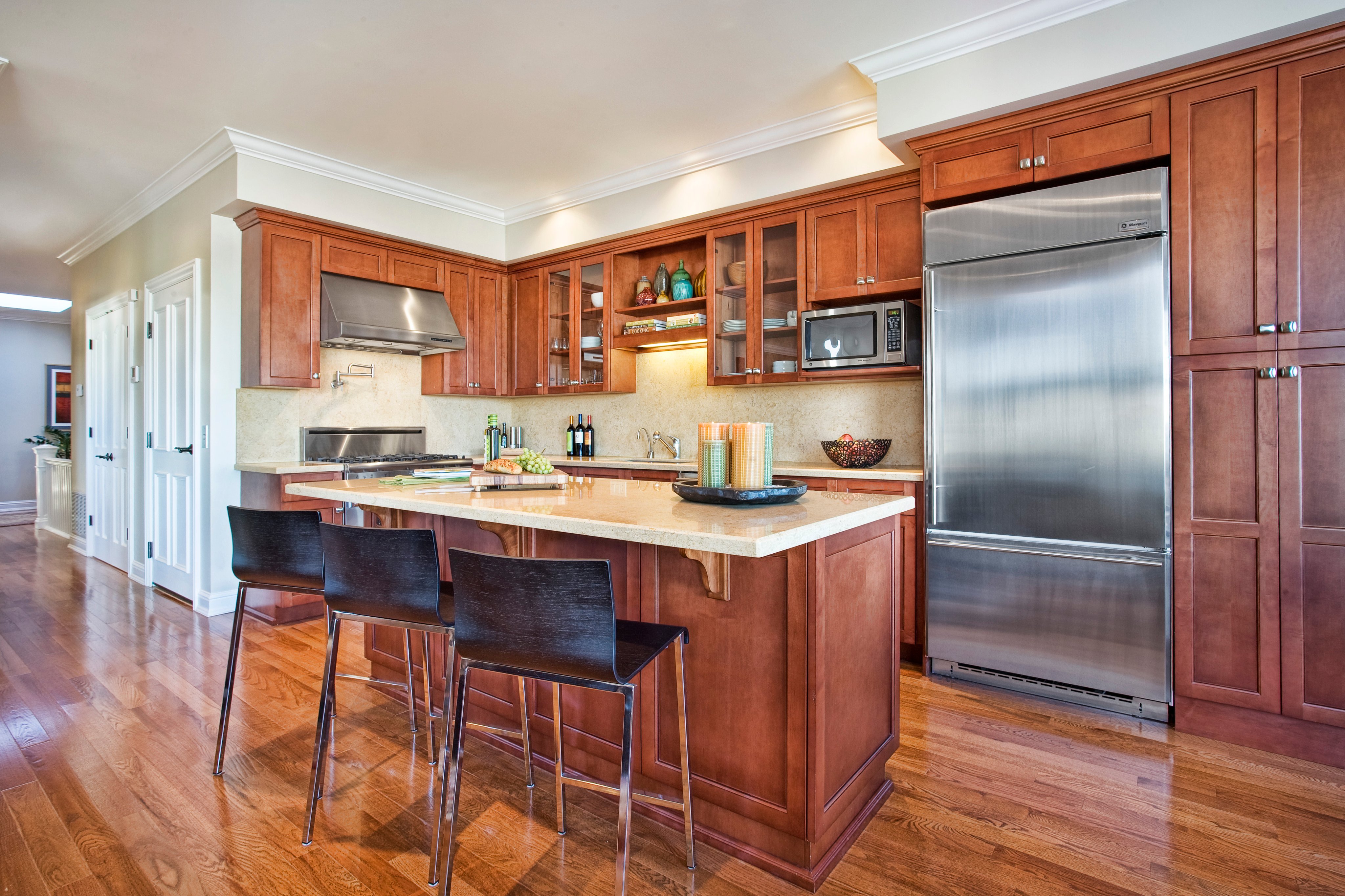 Green Street A Residence kitchen with cherry cabinets, island, and stainless appliances