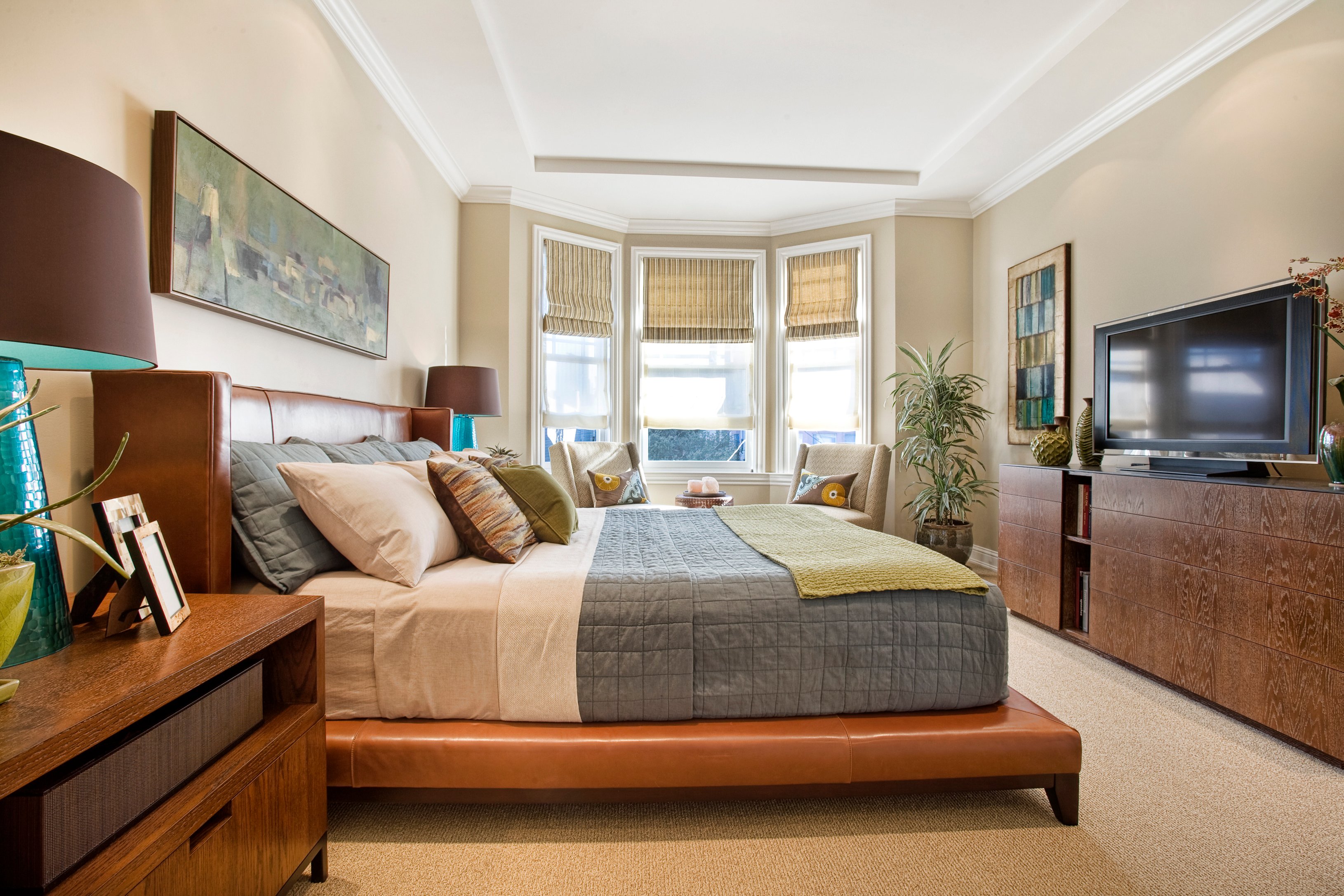 Green Street A Residence bedroom with upholstered bed and city views