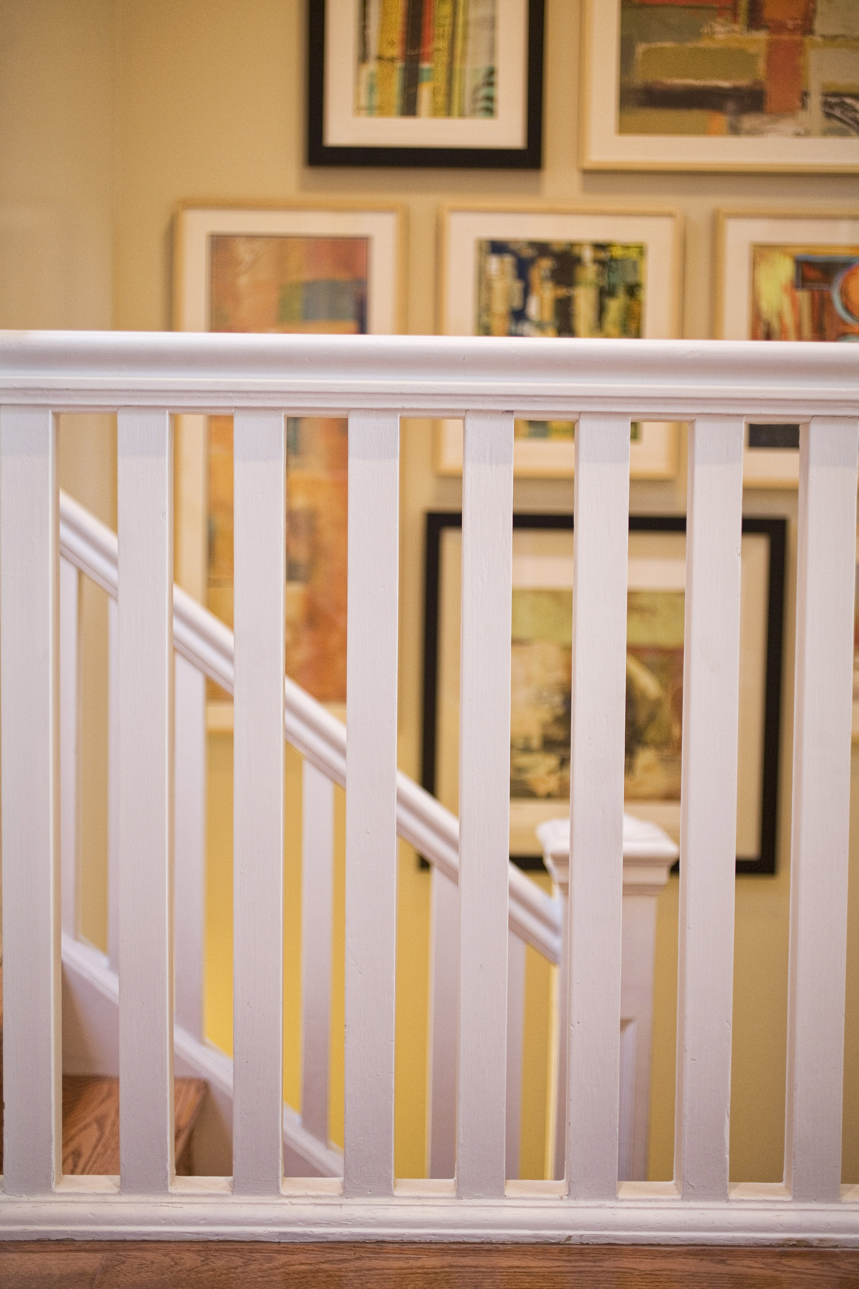 Green Street A Residence staircase with a framed gallery wall