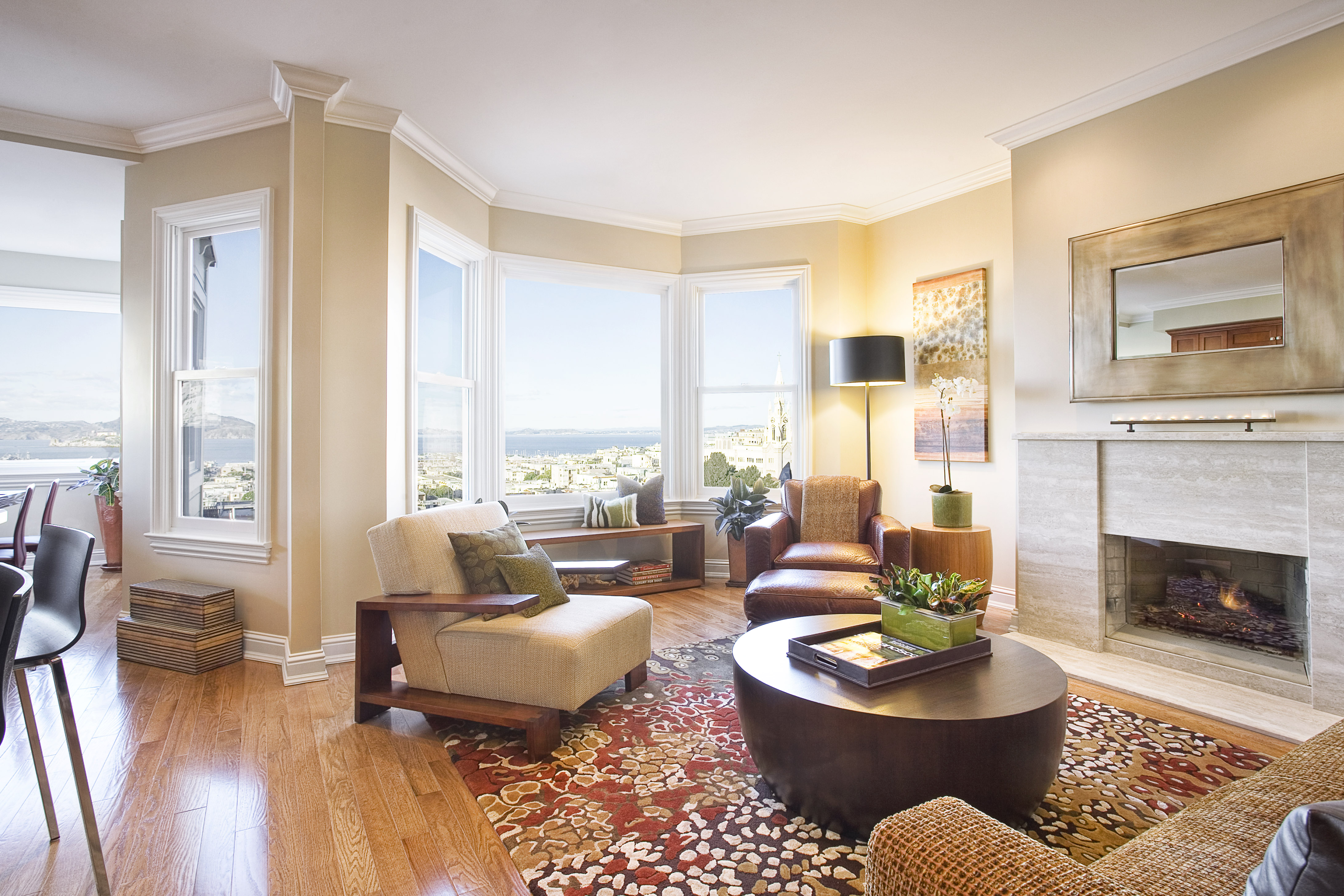 Green Street A Residence living room with bay windows, fireplace, and city views