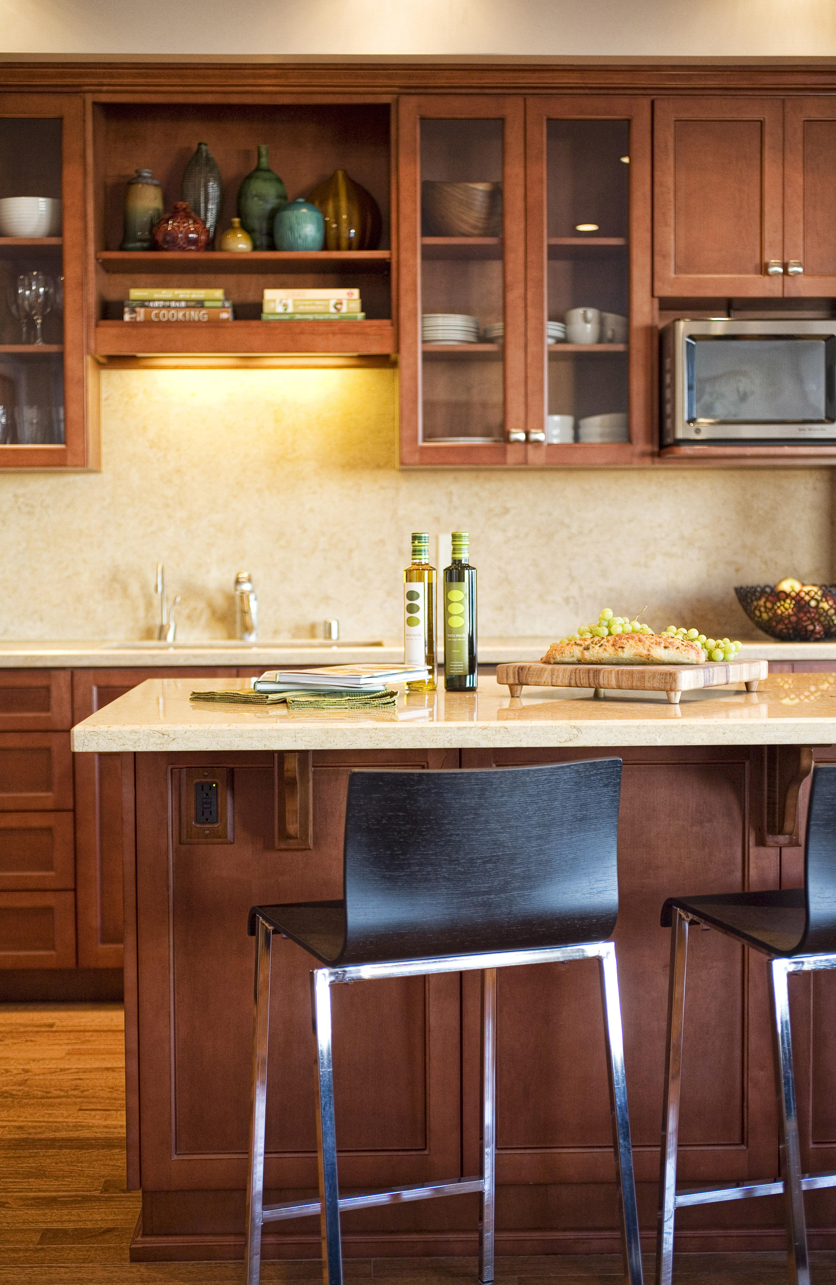 Green Street A Residence kitchen island with bar stools and cherry cabinetry