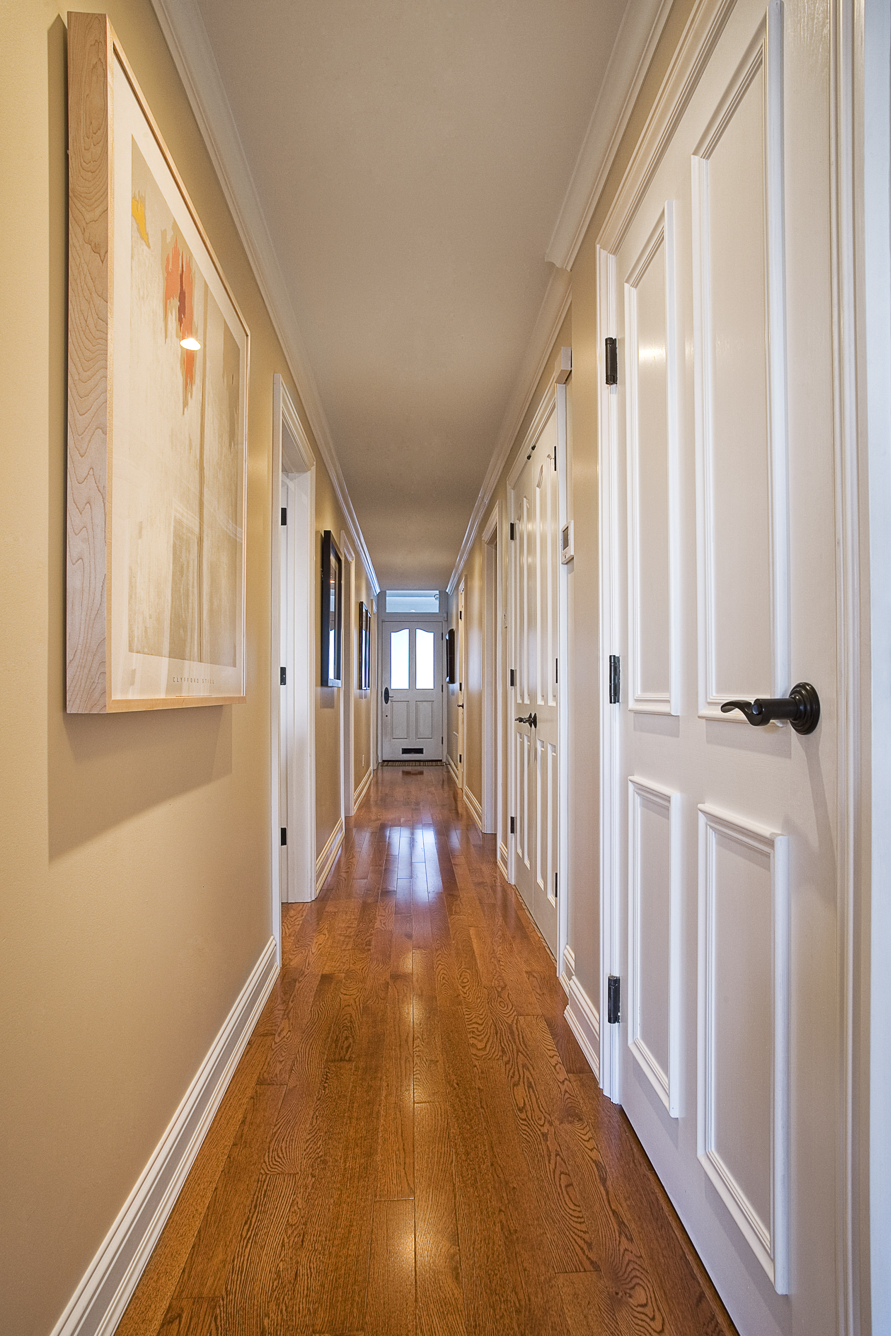 Green Street C Residence hallway with hardwood floors and white paneled doors
