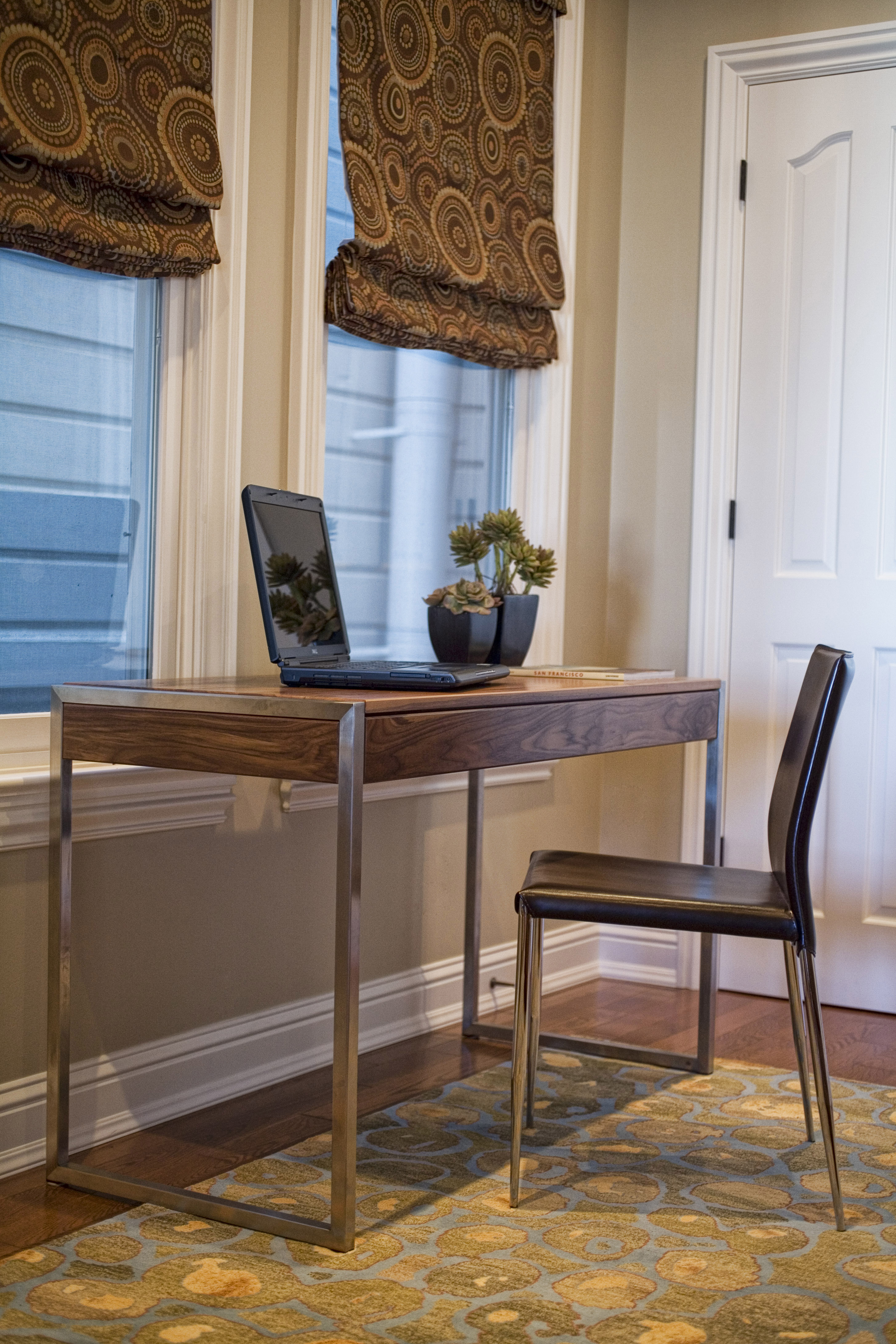 Green Street C Residence desk with laptop, chair, and window