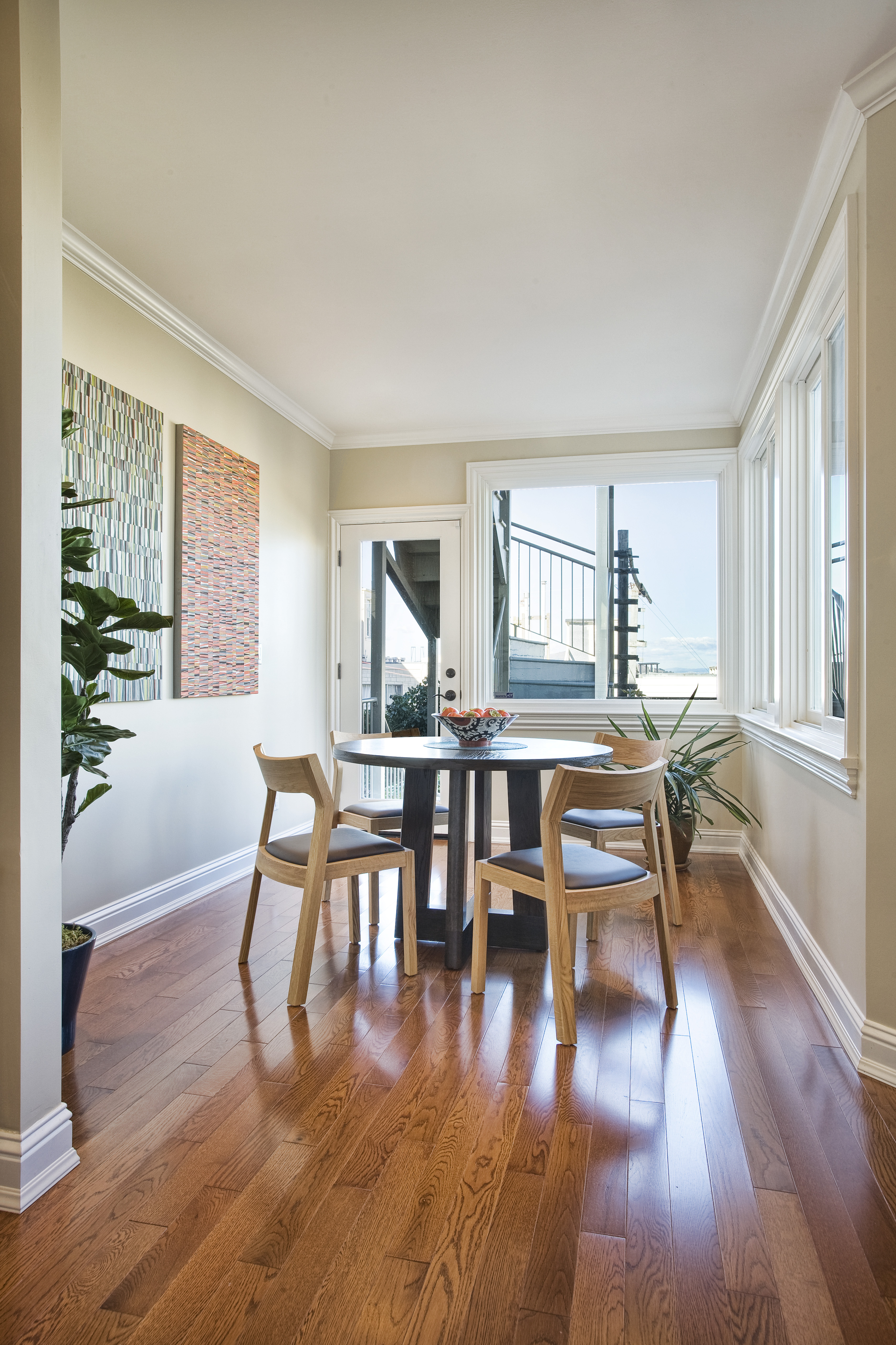 Green Street C Residence dining area with round table and wall art