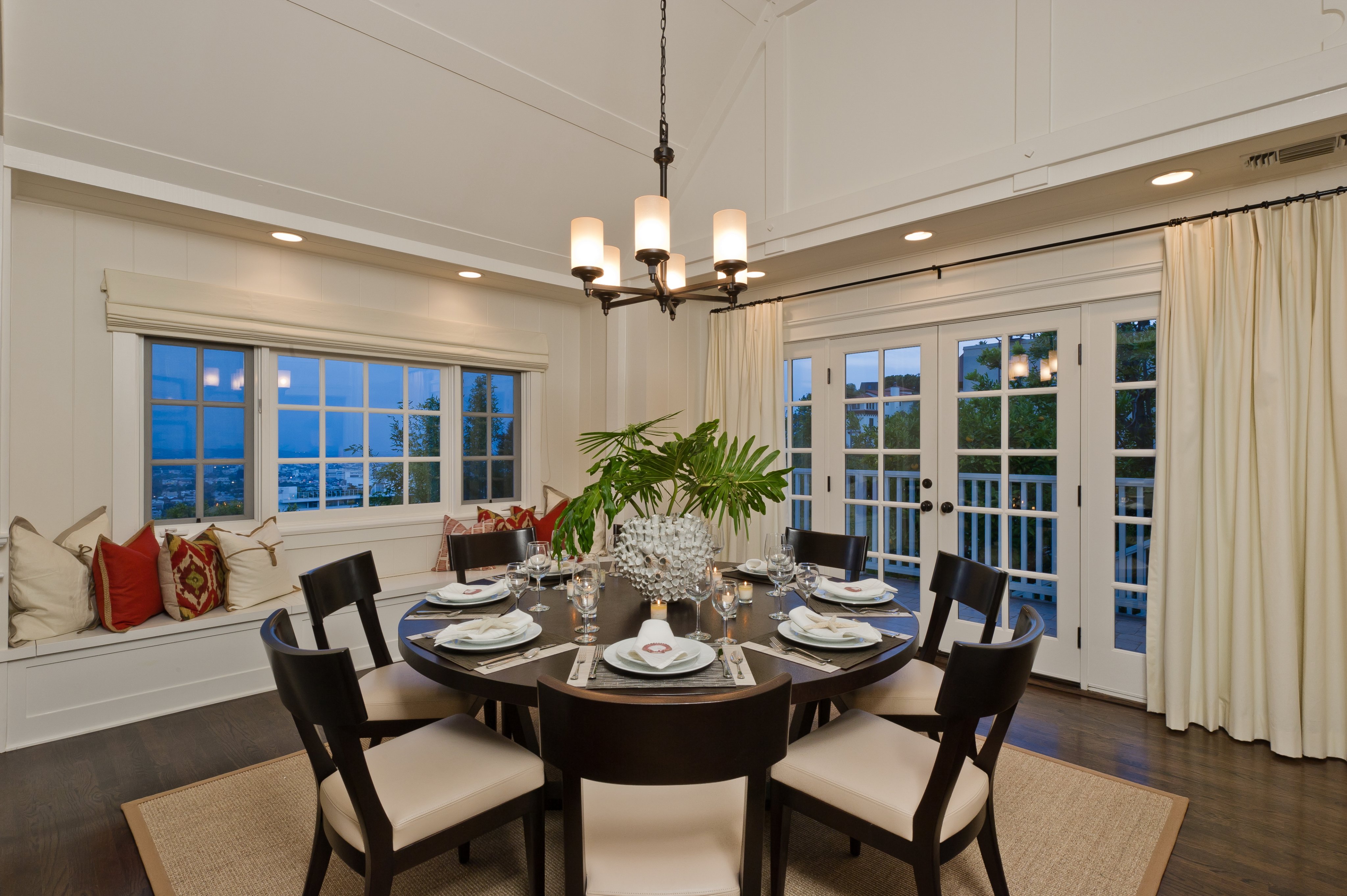 Dining room with a round table, built-in window seat, and views over Hollywood