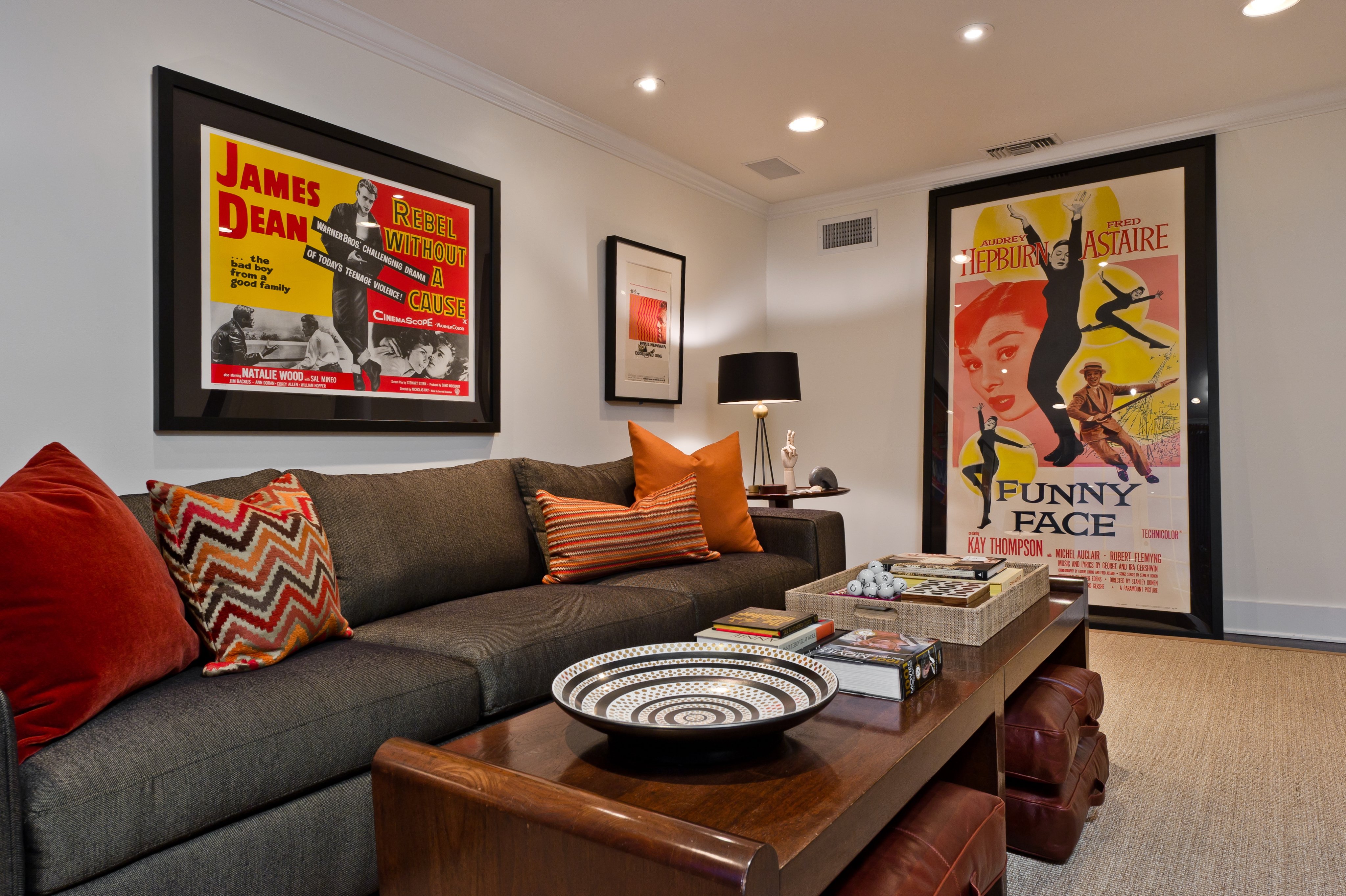 Media lounge with a sectional sofa and framed vintage movie posters