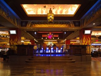 Casino bar beneath an illuminated flame ceiling panel