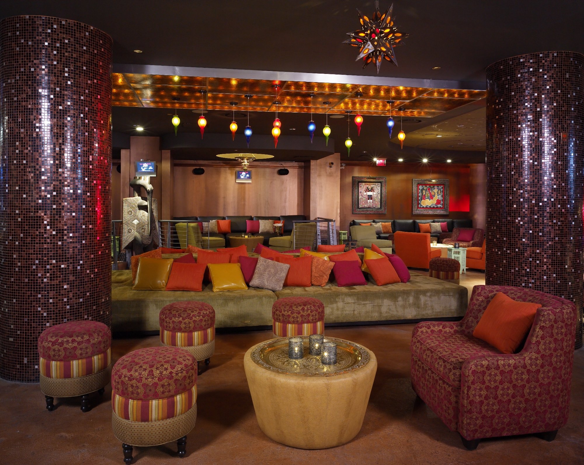 Nightclub lounge with colorful seating and glittering columns