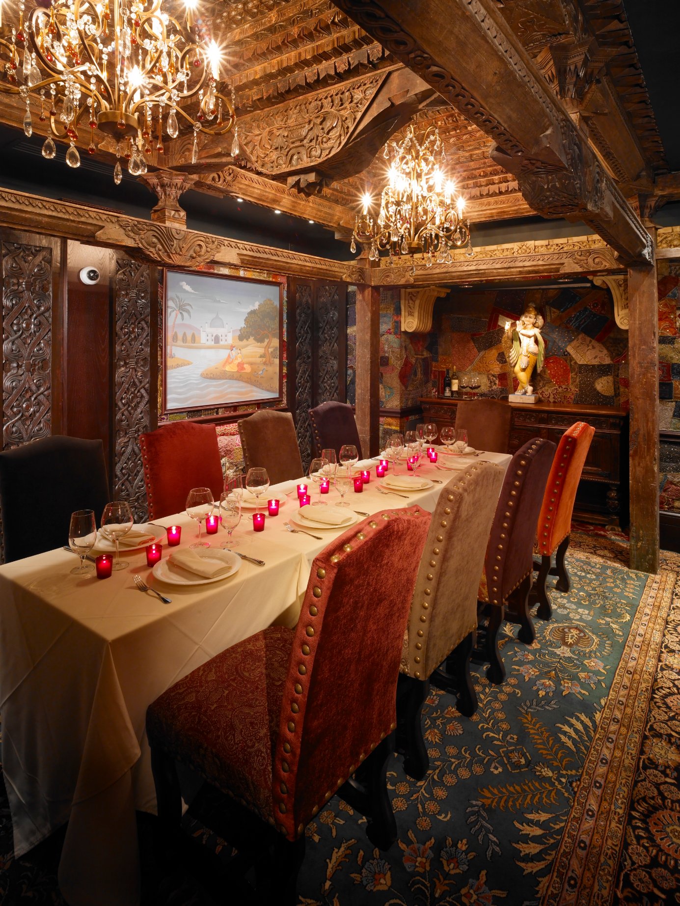 Intimate private dining room with crystal chandeliers and a long dressed table