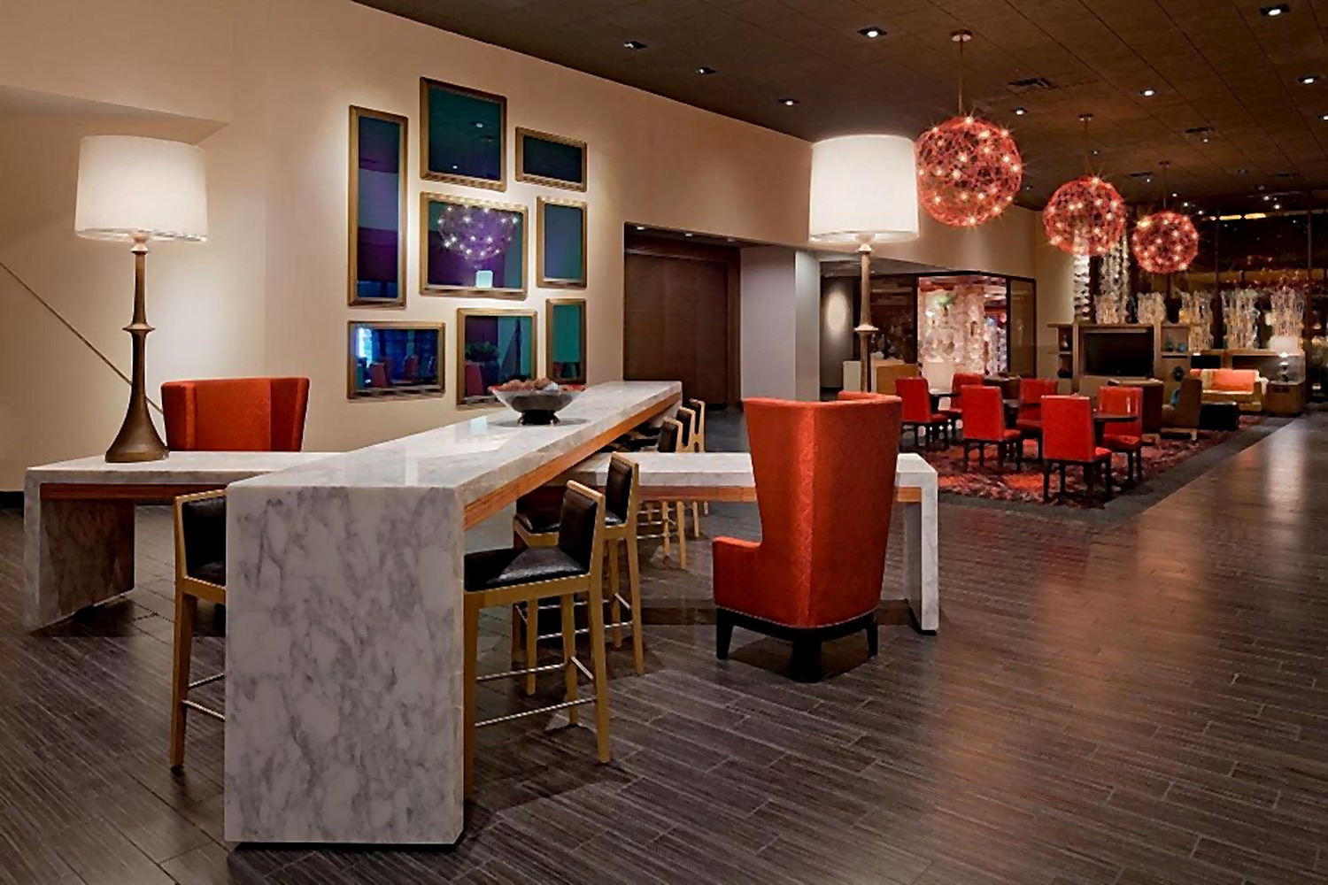 Hyatt Hotel business center with marble worktable and orange seating