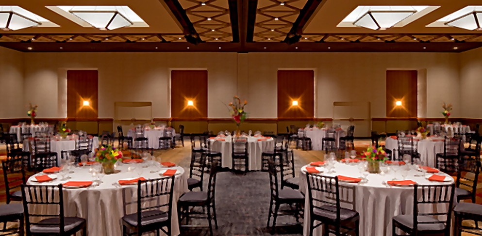 Hyatt Hotel ballroom arranged for dining beneath a geometric ceiling