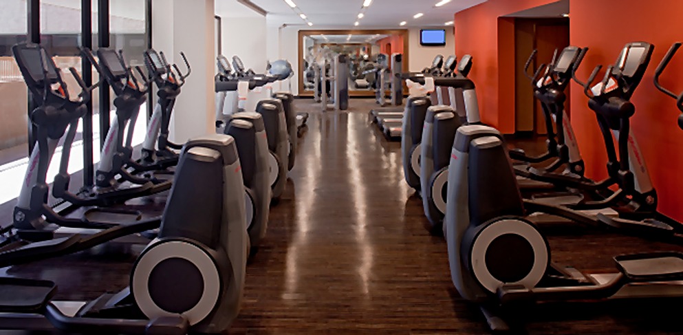 Hyatt Hotel fitness center with cardio equipment and wood-look flooring