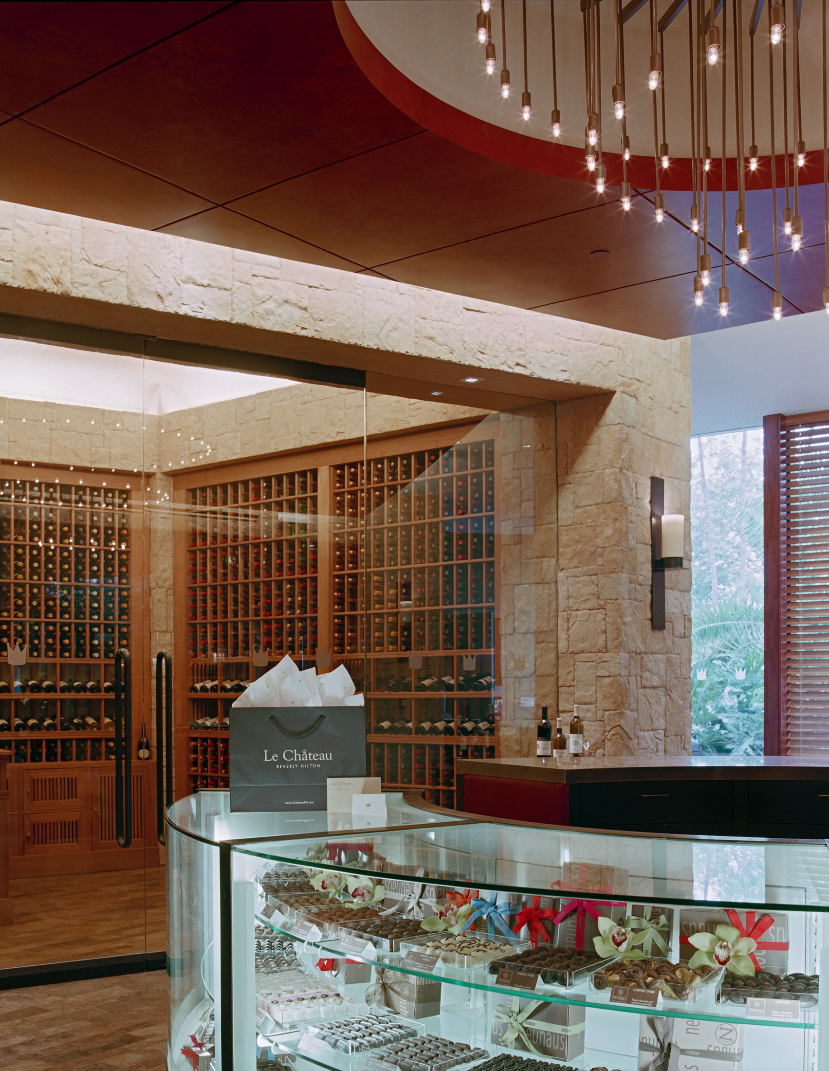 Le Chateau chocolate display case framed by stone walls and wine storage
