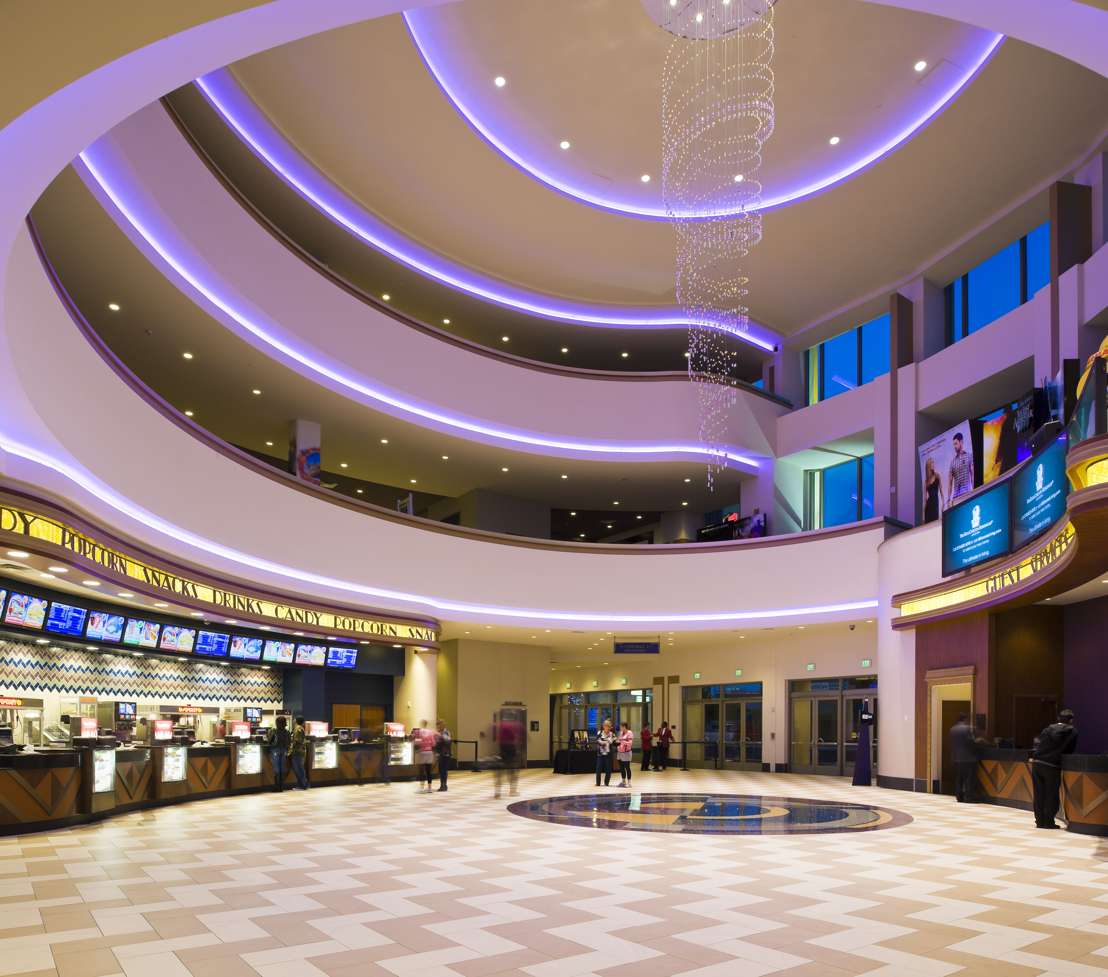 Regal Cinemas at LA Live grand lobby with a spiral chandelier and curved balconies