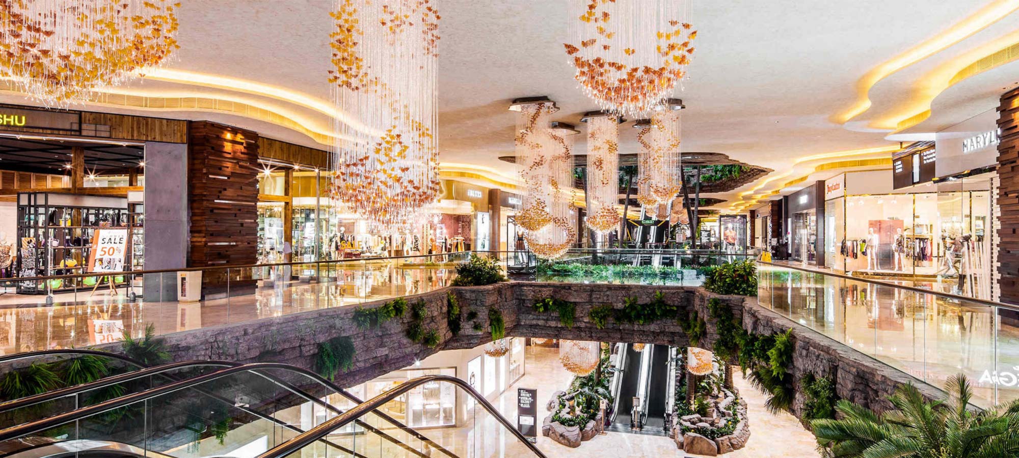 Retail mall level with cascading chandeliers and glass balustrades