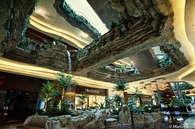 Rock-formation atrium with a waterfall and tropical planting