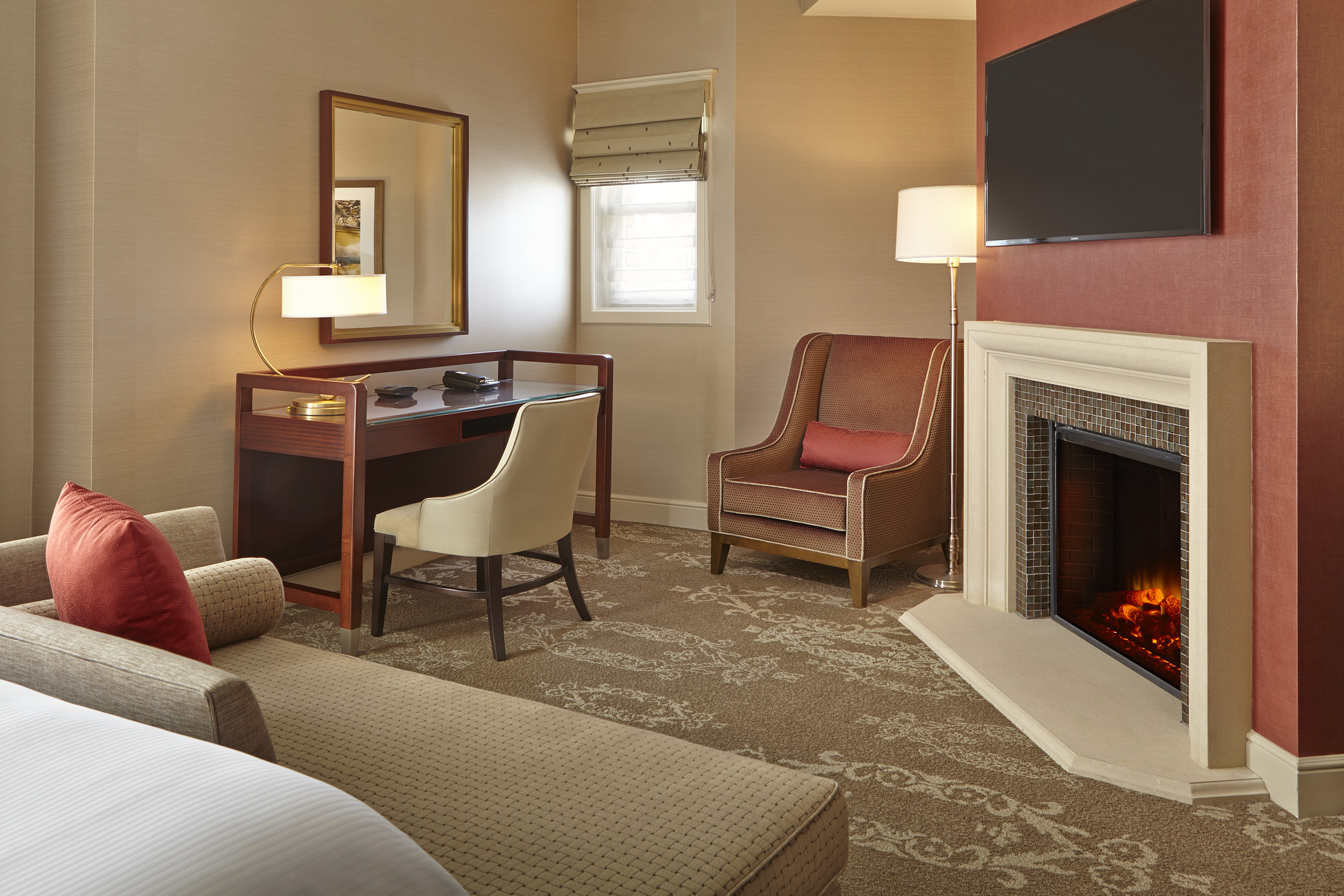 The Westin St Claire guest room with a fireplace, desk, and tailored seating