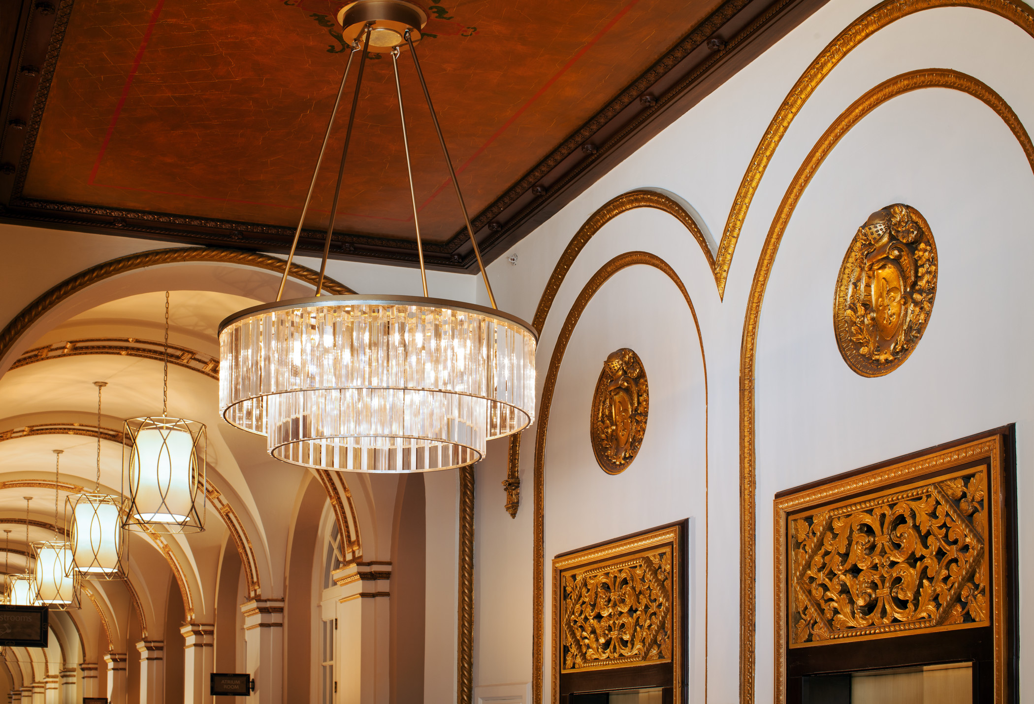 The Westin St Claire corridor with arched detailing and crystal chandeliers