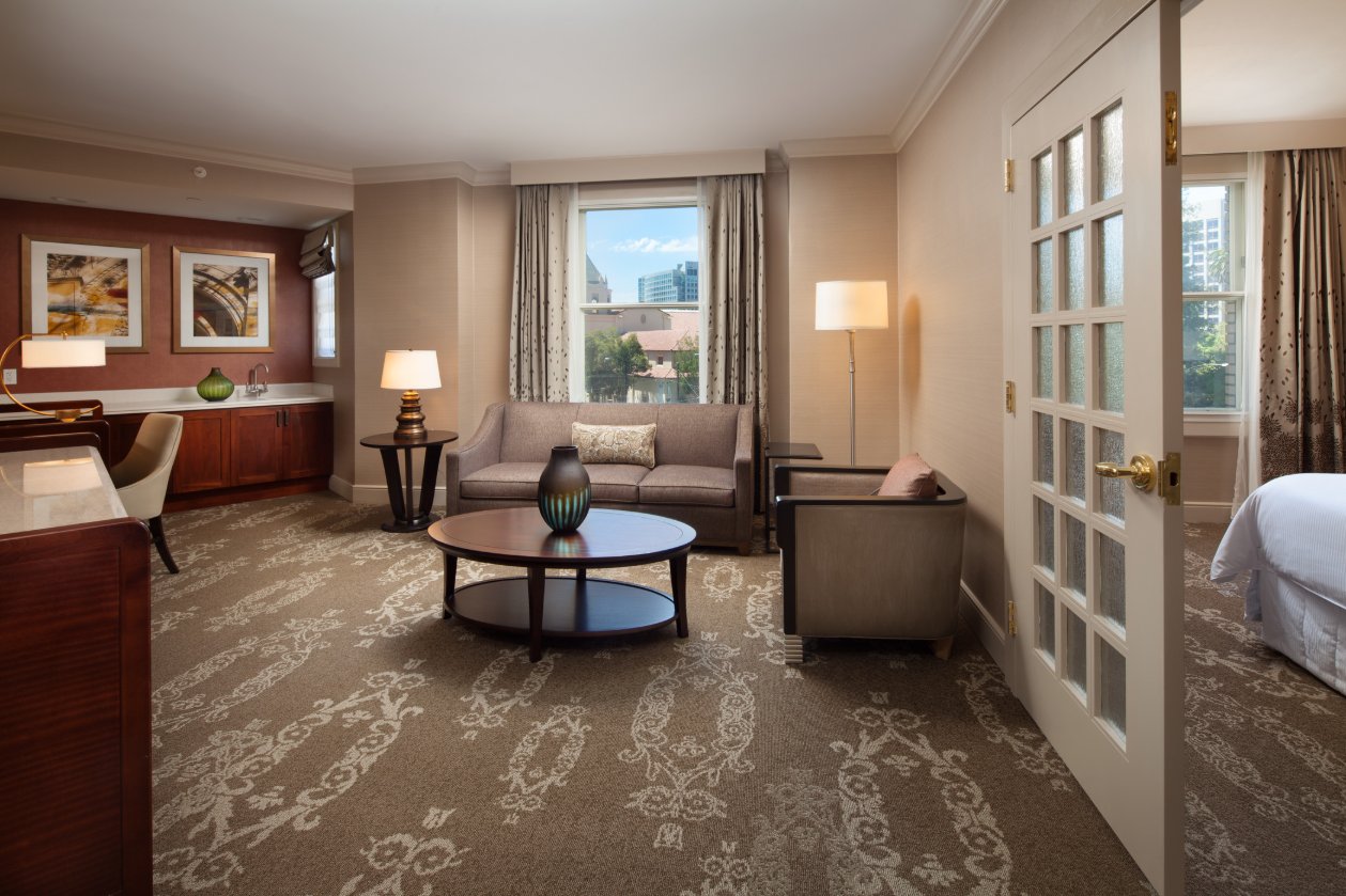 The Westin St Claire suite sitting room with neutral furnishings and garden views