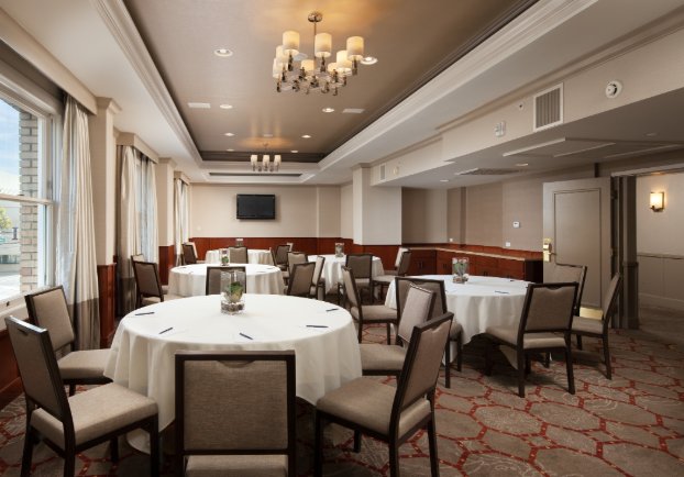 The Westin St Claire meeting room with round tables and chandelier lighting