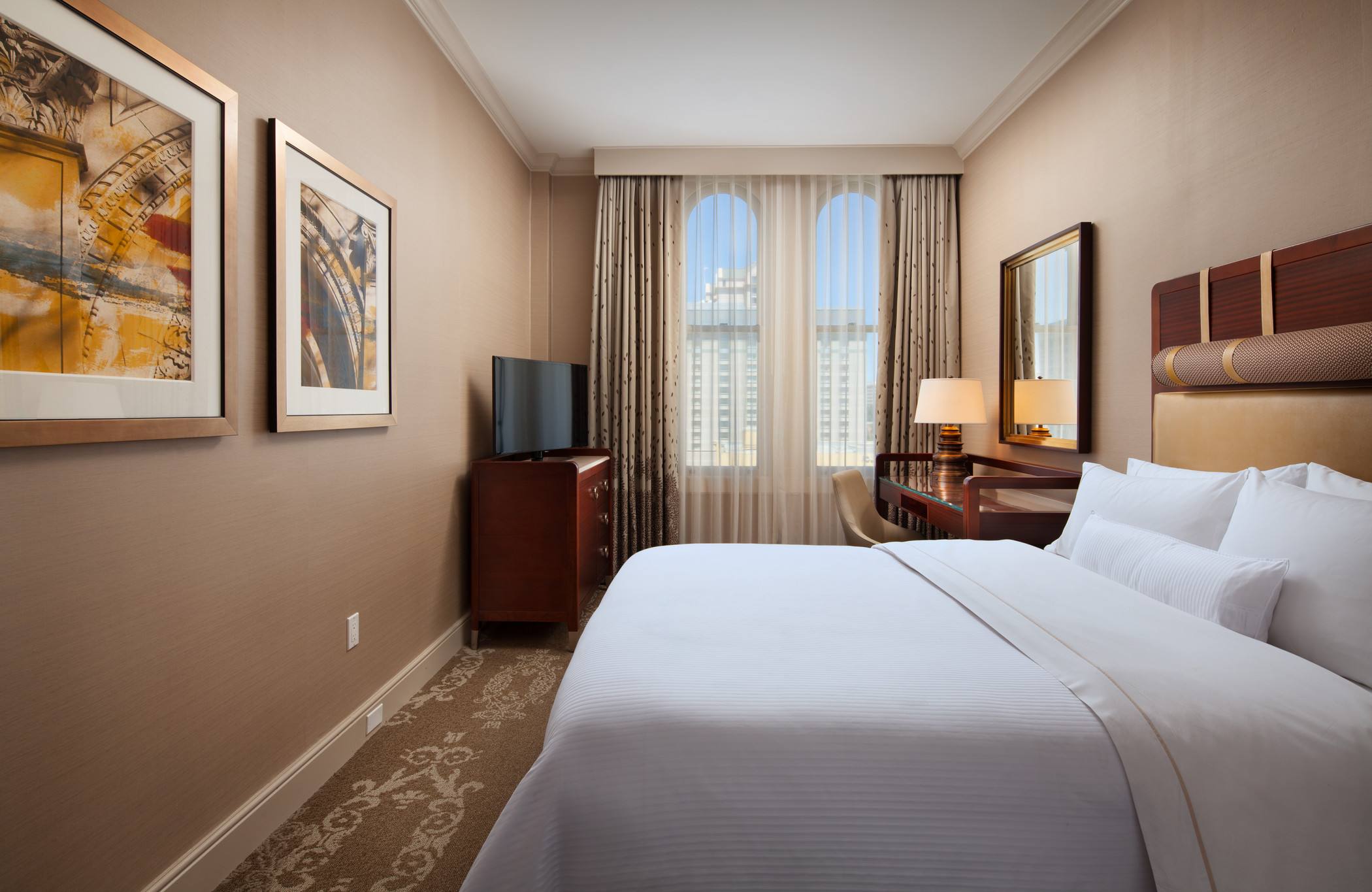The Westin St Claire king guest room with framed artwork and a bedside chair