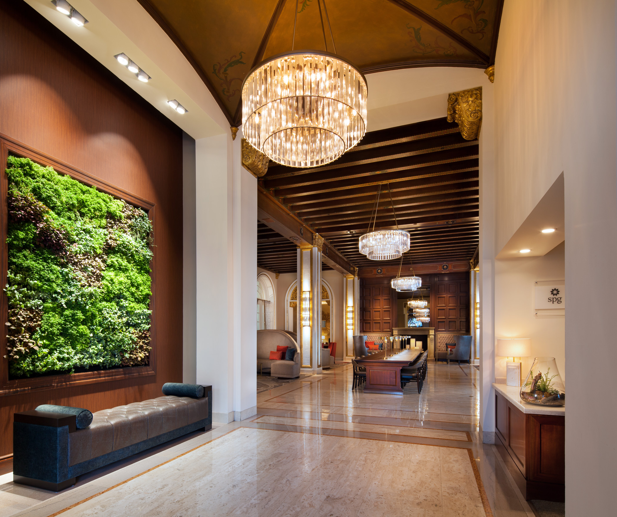 The Westin St Claire lobby with a living wall, fireplace, and chandelier