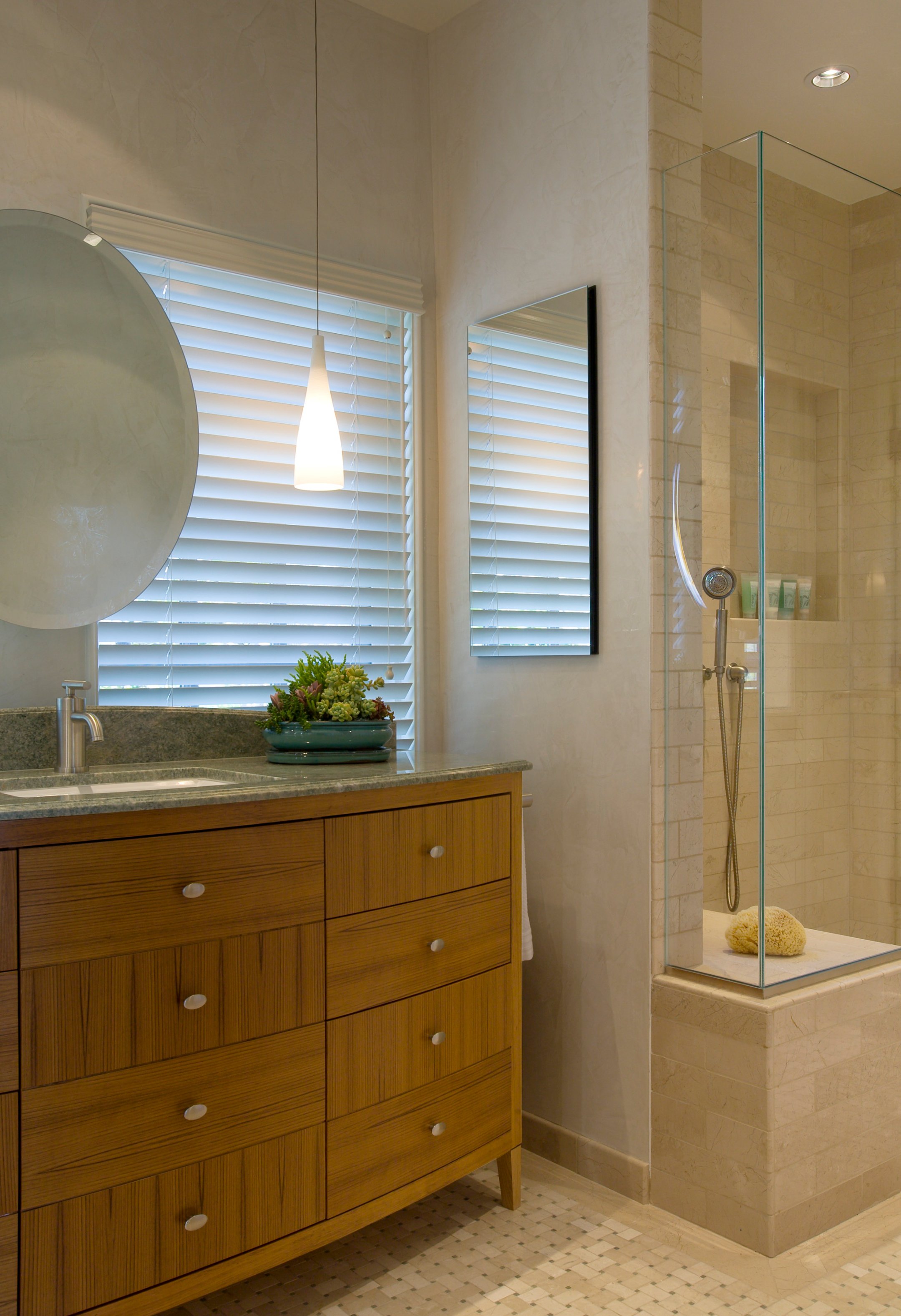 Garwood Residence bathroom with a warm wood vanity and large mirror