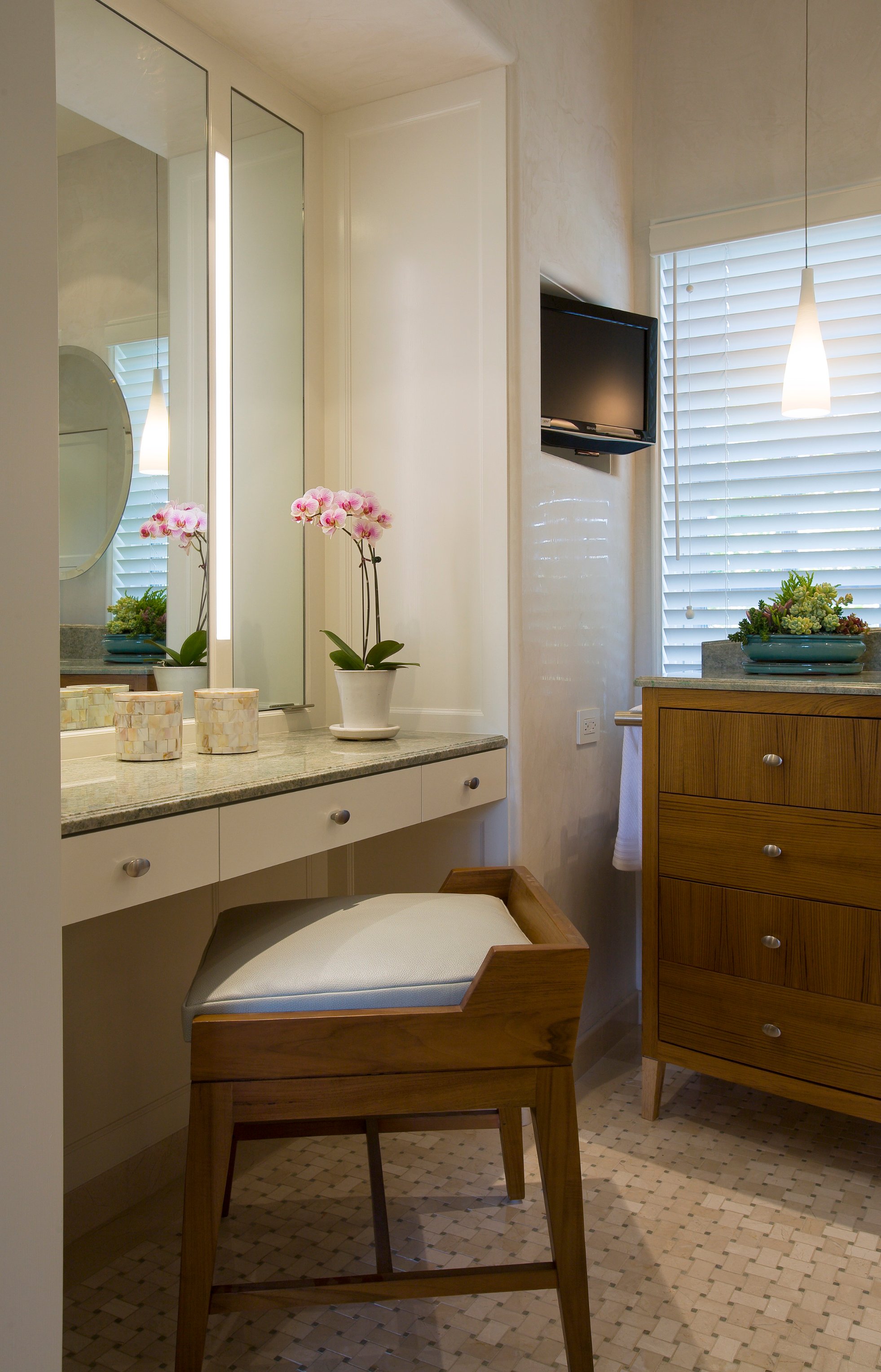 Garwood Residence bathroom vanity framed by pale stone tile